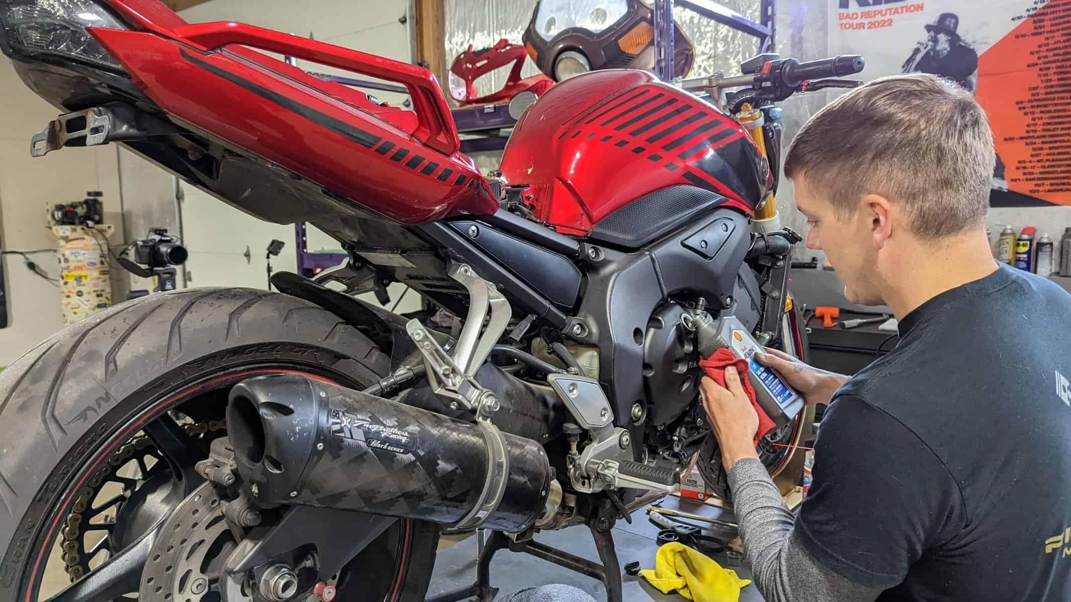 photo of ryne working on a motorcycle for a story about tips for new motorcycle riders